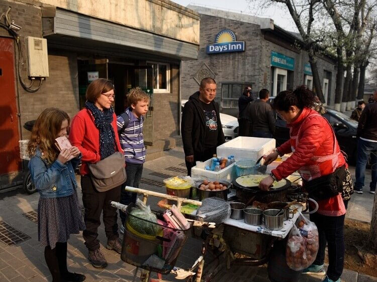 Chinese street food vendor making pancakes